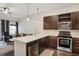 Modern kitchen with stainless steel appliances, quartz counters, and dark wood cabinets at 870 Inman Village Ne Pkwy # 222, Atlanta, GA 30307
