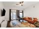 Bright living room with hardwood floors, a modern ceiling fan, and a comfortable leather sofa at 870 Inman Village Ne Pkwy # 222, Atlanta, GA 30307
