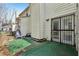 Backyard featuring a small artificial grass area and a door with a security gate at 122 Belmonte Sw Dr, Atlanta, GA 30311