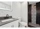 Modern bathroom featuring a stylish vanity with a gray countertop and a black and white tiled shower at 122 Belmonte Sw Dr, Atlanta, GA 30311