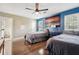 Comfortable bedroom featuring hardwood floors, ceiling fan, and a door to another bathroom at 122 Belmonte Sw Dr, Atlanta, GA 30311