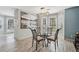 Bright dining area with a modern light fixture, large picture window, and neutral decor at 122 Belmonte Sw Dr, Atlanta, GA 30311