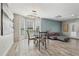 Open dining area with a modern light fixture, and an adjacent seating area with natural light at 122 Belmonte Sw Dr, Atlanta, GA 30311