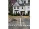 Charming townhome with a lovely yard, classic white siding, and reserved parking spaces right out front at 122 Belmonte Sw Dr, Atlanta, GA 30311