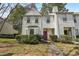 Inviting townhome featuring a pink front door, manicured landscaping, and a cozy exterior at 122 Belmonte Sw Dr, Atlanta, GA 30311