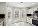 Bright kitchen eating area with large windows offering natural light and black subway backsplash at 122 Belmonte Sw Dr, Atlanta, GA 30311