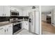 Well-lit kitchen featuring stainless steel appliances, granite countertops, and black subway tile backsplash at 122 Belmonte Sw Dr, Atlanta, GA 30311