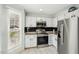 Well-lit kitchen featuring stainless steel appliances, white cabinets, and neutral backsplash at 122 Belmonte Sw Dr, Atlanta, GA 30311