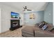 Cozy living room featuring a brick fireplace, a mounted television, and stylish decor at 122 Belmonte Sw Dr, Atlanta, GA 30311