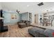 Open-concept living space featuring hardwood floors, modern decor, and a connecting dining area at 122 Belmonte Sw Dr, Atlanta, GA 30311