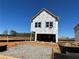 New construction home showing exterior framing details and wrapped for weather protection on a sunny day at 1227 Riverstone Rd, Jonesboro, GA 30238