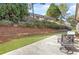 Landscaped backyard features retaining wall, small grass area, and patio seating area at 1874 Manor View Nw Cir # 4, Acworth, GA 30101