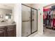 Bright bathroom with glass shower and a walk-in closet full of clothes and luggage at 1874 Manor View Nw Cir # 4, Acworth, GA 30101