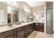 Spacious bathroom offers a large mirror over a dual vanity, a glass enclosed shower, and a walk-in closet at 1874 Manor View Nw Cir # 4, Acworth, GA 30101