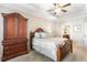Cozy bedroom with ceiling fan and tray ceiling is complimented by a dark wood dresser at 1874 Manor View Nw Cir # 4, Acworth, GA 30101