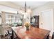 Open-concept dining area with a view into a sunny living room, featuring a beautiful chandelier at 1874 Manor View Nw Cir # 4, Acworth, GA 30101