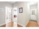 Bright hallway features hardwood floors and doorways leading to bathroom and office at 1874 Manor View Nw Cir # 4, Acworth, GA 30101