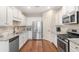 Well-equipped kitchen features stainless steel appliances, granite counters, and hardwood floors at 1874 Manor View Nw Cir # 4, Acworth, GA 30101