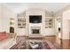 Comfortable living room with a brick fireplace, built-in shelves, and hardwood floors at 1874 Manor View Nw Cir # 4, Acworth, GA 30101