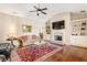 Bright living room with a fireplace, hardwood floors, and a comfortable seating area at 1874 Manor View Nw Cir # 4, Acworth, GA 30101