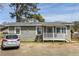 Charming single-story home with gray siding, a cozy porch, and well-maintained landscaping at 866 United Se Ave, Atlanta, GA 30312