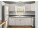 Functional kitchen with white cabinets, stainless steel appliances, and a window above the sink at 866 United Se Ave, Atlanta, GA 30312