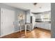 Open kitchen layout with stainless steel appliances, white cabinets, and hardwood floors at 866 United Se Ave, Atlanta, GA 30312