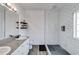 Modern bathroom with glass shower, granite countertop, and floating wood shelves at 121 Fox Wood Ct, Villa Rica, GA 30180