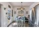 Bright dining area with modern light fixture, wood-look floors, and stainless-steel refrigerator at 121 Fox Wood Ct, Villa Rica, GA 30180