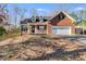 Traditional brick home featuring an attached garage and a cozy front porch at 121 Fox Wood Ct, Villa Rica, GA 30180