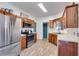 Well-lit kitchen featuring stainless steel appliances, warm wood cabinets, and modern tile floors at 121 Fox Wood Ct, Villa Rica, GA 30180