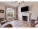 Comfortable living area with fireplace, large window, and wood-look flooring at 121 Fox Wood Ct, Villa Rica, GA 30180