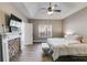 Inviting primary bedroom featuring a decorative fireplace, tray ceiling, and neutral color palette at 121 Fox Wood Ct, Villa Rica, GA 30180