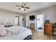 Spacious main bedroom with a cozy fireplace, neutral walls, and wood-look tile flooring at 121 Fox Wood Ct, Villa Rica, GA 30180