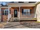 Close-up of the covered front porch with a decorative door and attractive landscaping at 121 Fox Wood Ct, Villa Rica, GA 30180
