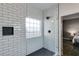 Modern tiled shower featuring glass enclosure and convenient window at 121 Fox Wood Ct, Villa Rica, GA 30180