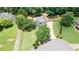 Aerial view of the home showcasing landscaping, driveway, and surrounding neighborhood in a serene setting at 2515 Little John Ct, Cumming, GA 30040