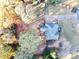 Aerial view of a home surrounded by lush trees with a spacious driveway and backyard at 2515 Little John Ct, Cumming, GA 30040