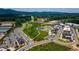 Aerial view of the community showcasing the layout with parks, roads, commercial buildings, and parking areas at 2515 Little John Ct, Cumming, GA 30040