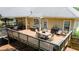 Spacious back deck, perfect for outdoor dining and entertaining with string lights and backyard views at 2515 Little John Ct, Cumming, GA 30040