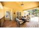 Inviting covered back porch with comfortable seating, ceiling fan and view of the backyard at 2515 Little John Ct, Cumming, GA 30040