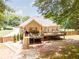 Exterior view of an elevated back porch and deck with stairs leading to a spacious backyard with wood privacy fence at 2515 Little John Ct, Cumming, GA 30040
