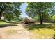 Expansive fenced backyard with a view of the home's back deck and exterior, surrounded by lush greenery at 2515 Little John Ct, Cumming, GA 30040
