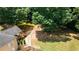 Aerial view of the backyard, showcasing the deck, landscaping, and private setting surrounded by mature trees at 2515 Little John Ct, Cumming, GA 30040