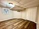 Finished basement with wood-look flooring, ample lighting, and closet space at 2515 Little John Ct, Cumming, GA 30040