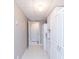 Hallway with white cabinets, neutral paint and light tile to walk through from a finished basement at 2515 Little John Ct, Cumming, GA 30040