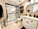 Updated bathroom featuring a glass door shower and modern vanity with a round mirror at 2515 Little John Ct, Cumming, GA 30040