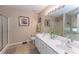 Bathroom featuring double sinks with a large mirror, separate shower, and soaking tub at 2515 Little John Ct, Cumming, GA 30040