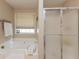 Modern bathroom with soaking tub next to a glass-door shower at 2515 Little John Ct, Cumming, GA 30040