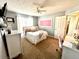 Comfortable bedroom featuring a bed with fluffy pillows, neutral walls, and a writing desk at 2515 Little John Ct, Cumming, GA 30040